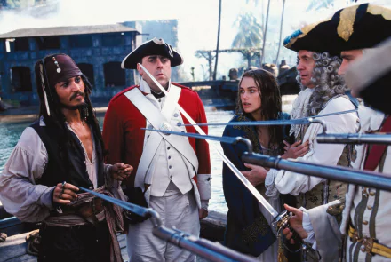 A scene from Pirates Of The Caribbean: The Curse Of The Black Pearl featuring Jack Sparrow, Elizabeth Swann, and other characters in a tense standoff.