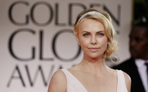 High-resolution 4K Ultra HD desktop wallpaper featuring celebrity Charlize Theron at the Golden Globe Awards, showcasing her elegant look and poised expression.