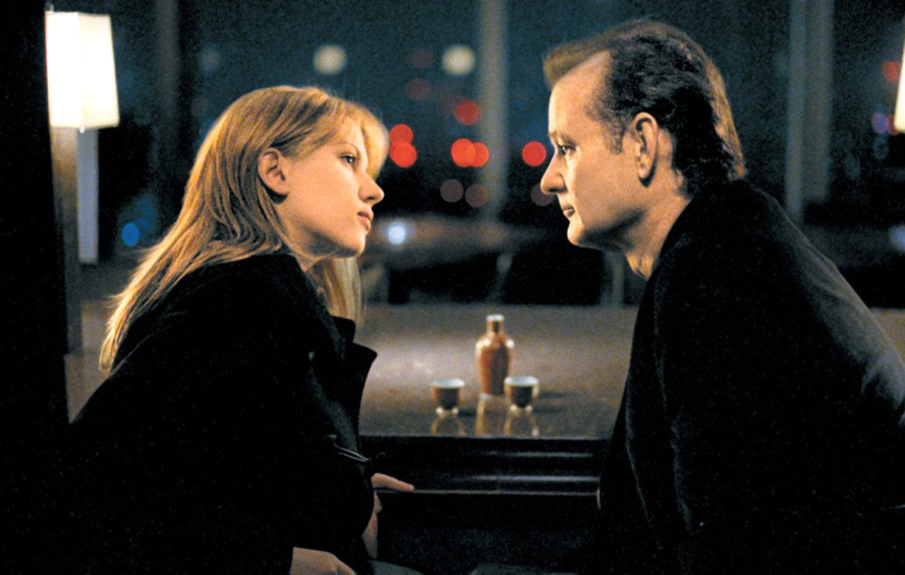 HD desktop wallpaper featuring Bill Murray and Scarlett Johansson in a scene from the movie Lost In Translation, with a softly lit background.