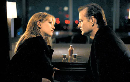 HD desktop wallpaper featuring Bill Murray and Scarlett Johansson in a scene from the movie Lost In Translation, with a softly lit background.