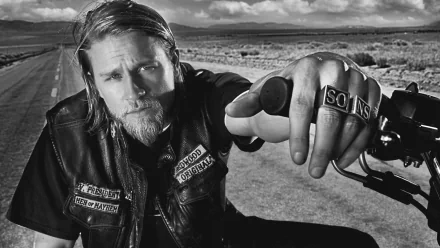 Black and white HD desktop wallpaper featuring a Sons of Anarchy character in biker attire, set against a deserted road and open landscape from the TV show.