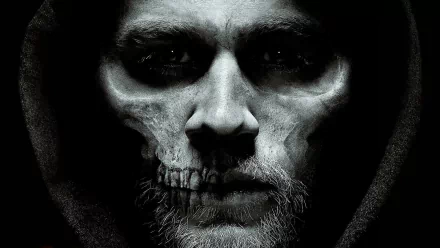 A striking HD desktop wallpaper from the TV show Sons of Anarchy, featuring a dramatic close-up of a character with a skull face, set against a dark background.