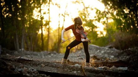 HD desktop wallpaper featuring Lindsey Stirling passionately playing the violin outdoors at sunset, surrounded by trees and rocky terrain.