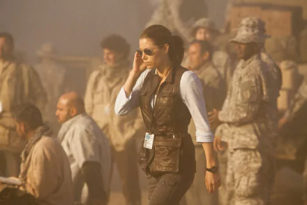 Jessica Biel in a scene from the movie The A-Team, walking confidently among a group of military personnel in a dusty, intense environment. HD desktop wallpaper background.