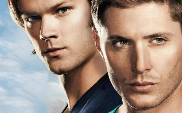 HD wallpaper featuring Jensen Ackles as Dean Winchester and Jared Padalecki as Sam Winchester from the TV show Supernatural, set against a vibrant sky backdrop.