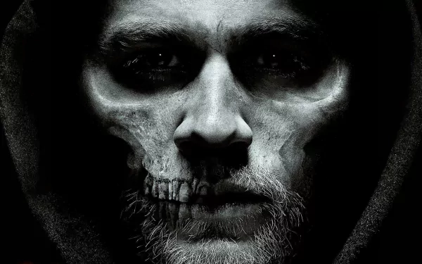 A striking HD desktop wallpaper from the TV show Sons of Anarchy, featuring a dramatic close-up of a character with a skull face, set against a dark background.