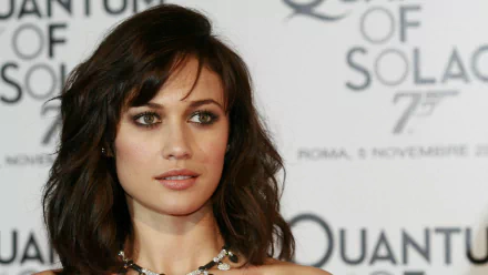 Olga Kurylenko poses gracefully at a promotional event for Quantum of Solace, showcasing her elegance in this high-definition desktop wallpaper.