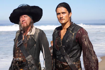 HD movie wallpaper featuring Will Turner (Orlando Bloom) and Hector Barbossa (Geoffrey Rush) from Pirates of the Caribbean: At World's End, standing on a beach.