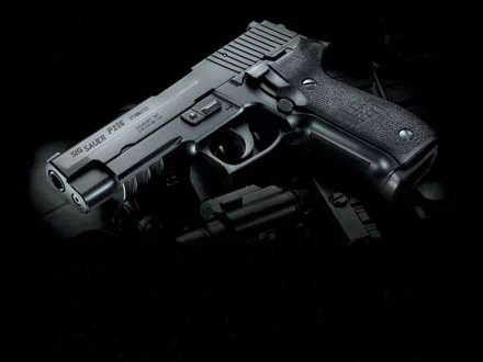 HD PC desktop wallpaper showing a man-made Sig Sauer P226 handgun on a dark background with dramatic low-key lighting.