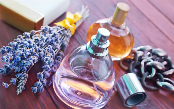 An elegant composition featuring perfume bottles, lavender sprigs, and chic accessories, captured in vibrant detail for a stunning HD desktop wallpaper.