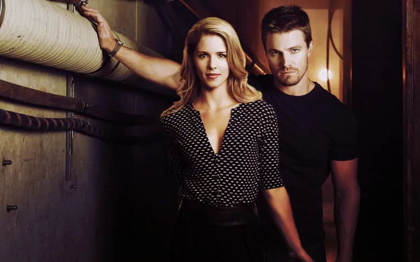 Felicity Smoak and Oliver Queen from the TV show Arrow pose together in a dramatic setting, showcasing their strong connection. A vibrant HD wallpaper for fans of the series.