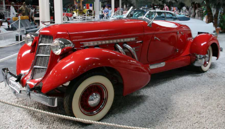 HD PC desktop wallpaper featuring a red Auburn 851 Speedster classic vehicle with chrome accents and whitewall tires on display.