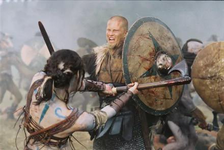 HD PC desktop wallpaper featuring Til Schweiger in a dramatic battle scene from the movie King Arthur, showcasing intense medieval combat with swords and shields.