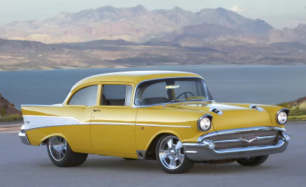 Yellow Chevrolet Bel Air Project X car parked by a lake with mountains in the background, showcased as an HD PC desktop wallpaper and background.