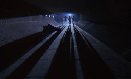 HD desktop wallpaper from the movie A Clockwork Orange, featuring silhouetted figures casting long shadows in a dark, narrow tunnel.