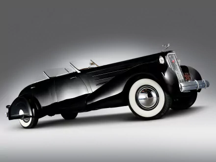 HD PC desktop wallpaper: black Cadillac V-16 roadster with whitewall tires and sleek Art Deco curves on a soft gray gradient background.