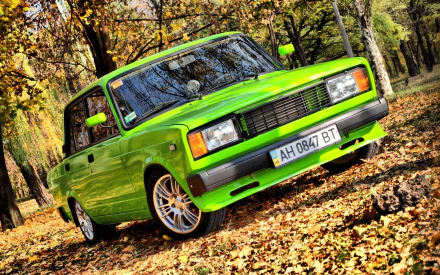 Bright lime-green Lada vehicle on autumn leaves in a forest, HD PC desktop wallpaper and background.