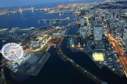 A 4K Ultra HD aerial view of Yokohama, Japan at night, showcasing the illuminated cityscape, waterfront, and a large Ferris wheel along the harbor.