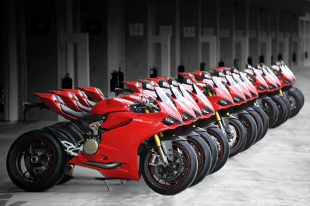HD PC desktop wallpaper/background: row of red Ducati 1199 sportbike vehicles lined up in a garage, angled toward the viewer.