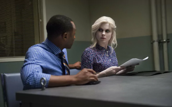 Malcolm Goodwin and Rose McIver in a tense scene from the TV show iZombie, featured in an HD PC desktop wallpaper.