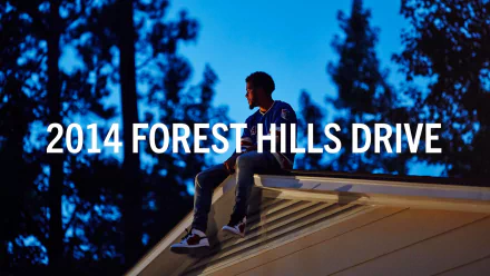 HD PC desktop wallpaper: a musician sits on a rooftop at dusk with large white text 2014 FOREST HILLS DRIVE against a blue forest silhouette — music-themed background.