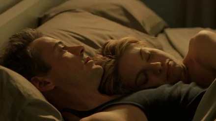 HD PC wallpaper: intimate bedside shot of two characters asleep together in a dimly lit scene from the movie Kiss Kiss Bang Bang.