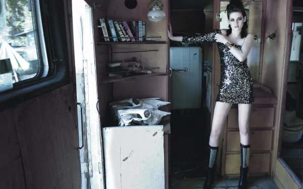 A striking 4K Ultra HD wallpaper featuring Kristen Stewart in a glamorous outfit, posing confidently in an eclectic interior space. The image captures a blend of style and attitude.