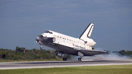 Space Shuttle Atlantis landing on a runway, captured in high definition as a desktop wallpaper showcasing this iconic space vehicle against a clear sky.