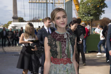 Portrait of celebrity Kiernan Shipka in an elegant dress at an outdoor event, captured in 4K Ultra HD quality as a PC desktop wallpaper and background.