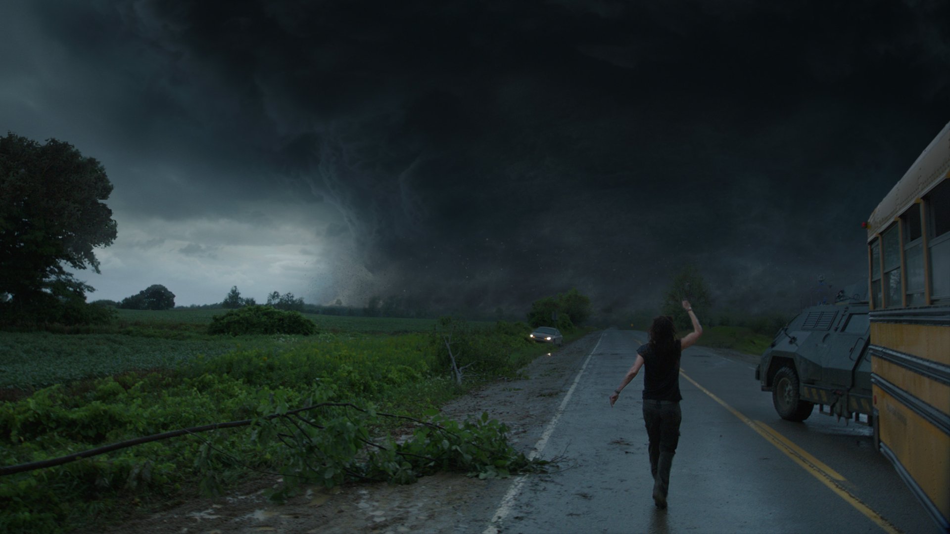 HD PC desktop wallpaper featuring a dark storm cloud from the movie Into the Storm, capturing an intense storm scene with a person running on a deserted road.
