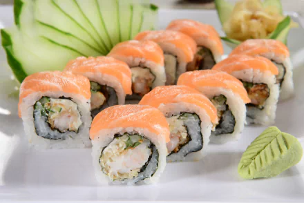 A vibrant display of sushi rolls, featuring fresh fish and rice, complemented by wasabi and cucumber garnishes. This 4K Ultra HD image captures the essence of Japanese cuisine.