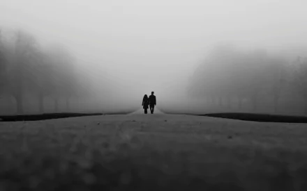A couple walks hand in hand along a foggy path in the morning, captured in a serene black-and-white photography HD wallpaper evoking love and quiet connection.