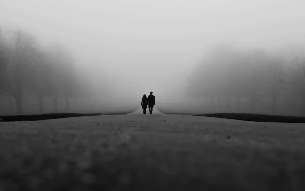 A couple walks hand in hand along a foggy path in the morning, captured in a serene black-and-white photography HD wallpaper evoking love and quiet connection.
