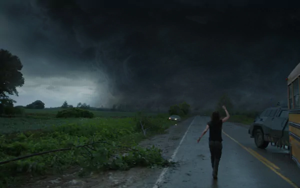 HD PC desktop wallpaper featuring a dark storm cloud from the movie Into the Storm, capturing an intense storm scene with a person running on a deserted road.