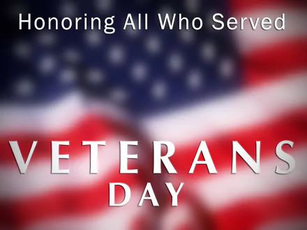 HD PC desktop wallpaper: blurred American flag background with Honoring All Who Served and bold VETERANS DAY text for the Veterans Day holiday
