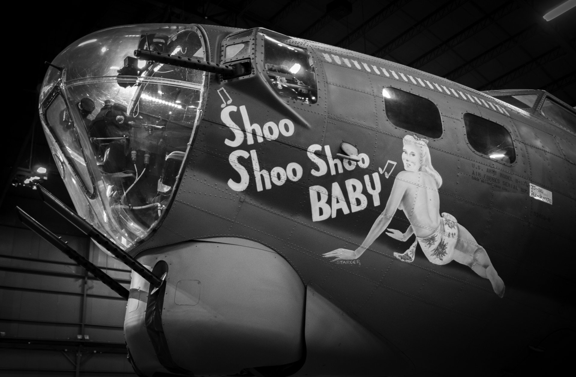 Black-and-white close-up of Boeing B-17 Flying Fortress nose art reading Shoo Shoo Baby with pin-up on a military bomber, presented as a 4K Ultra HD PC desktop wallpaper/background.
