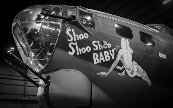 Black-and-white close-up of Boeing B-17 Flying Fortress nose art reading Shoo Shoo Baby with pin-up on a military bomber, presented as a 4K Ultra HD PC desktop wallpaper/background.