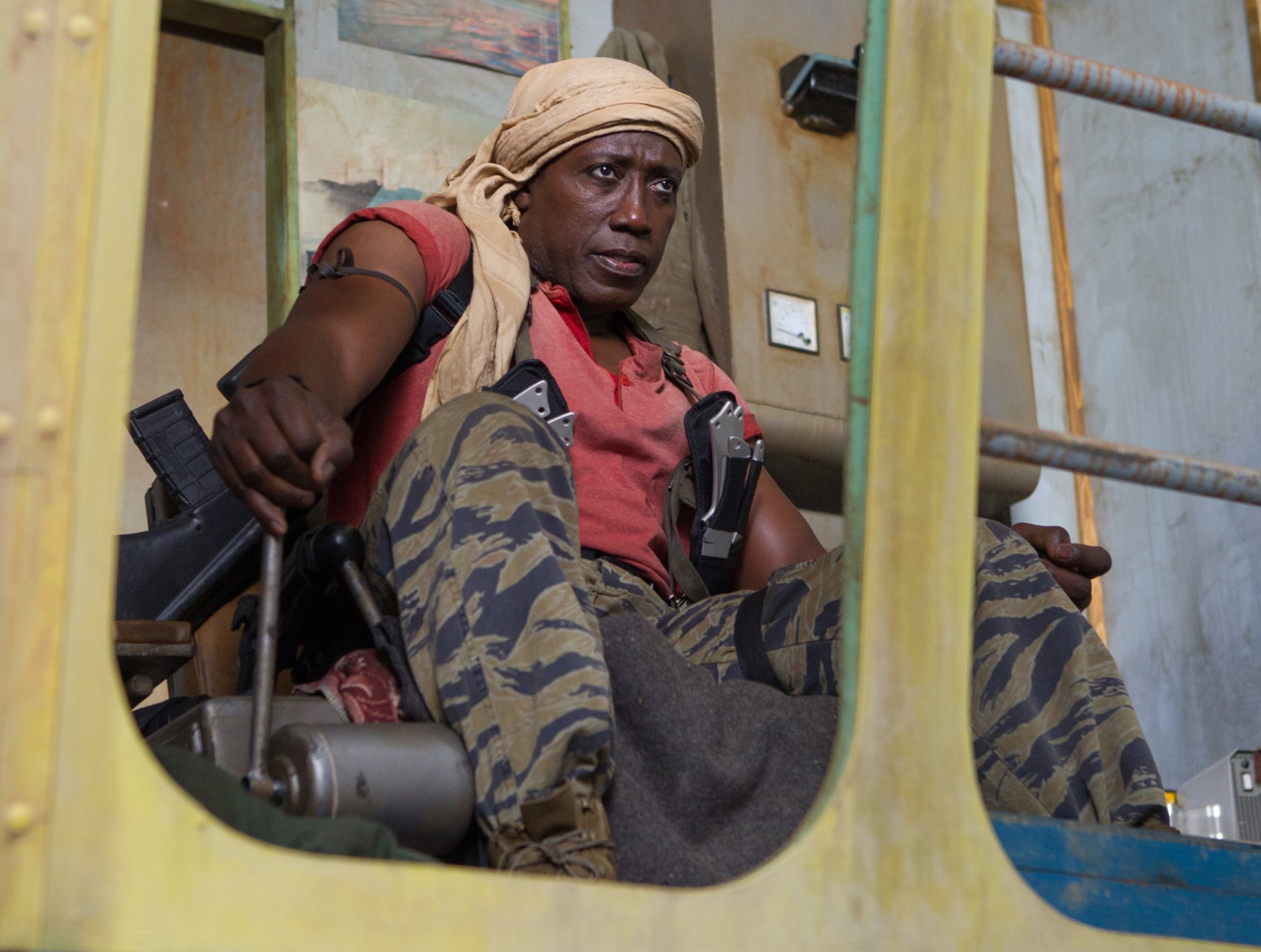 HD PC desktop wallpaper of Doc from The Expendables 3: seated, armed mercenary in camo pants and a headwrap, gripping gear inside a vehicle.