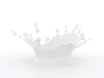 HD desktop wallpaper featuring a splash of milk in mid-air, with droplets frozen in motion against a white background.