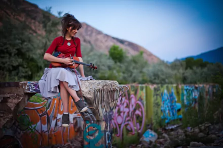 A vibrant 4K Ultra HD wallpaper featuring Lindsey Stirling playing the violin against a backdrop of colorful graffiti and lush greenery, capturing a moment of musical artistry.