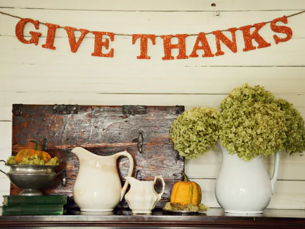 Thanksgiving holiday scene featuring a Give Thanks banner, rustic decor with pumpkins, white pitchers, and green hydrangeas, rendered in 4K Ultra HD for PC desktop wallpaper.