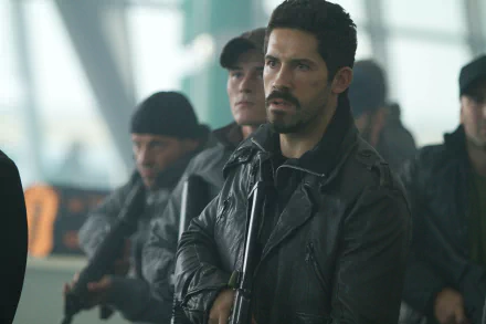 Hector, played by Scott Adkins in The Expendables 2, stands alert in a tactical leather jacket with a group of armed men in this 4K Ultra HD movie wallpaper.