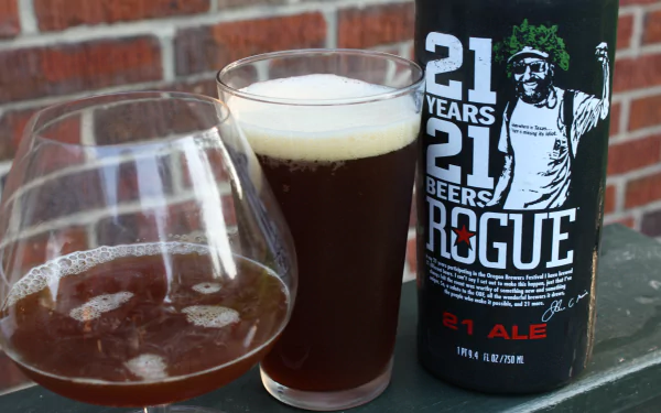 Food, beer 4K Ultra HD PC desktop wallpaper background: Rogue 21 Ale bottle with a pint and a snifter of dark ale on a green railing against a brick wall.