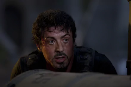 Sylvester Stallone as Barney Ross in a dramatic scene from *The Expendables*. This 4K Ultra HD wallpaper captures action and intensity.