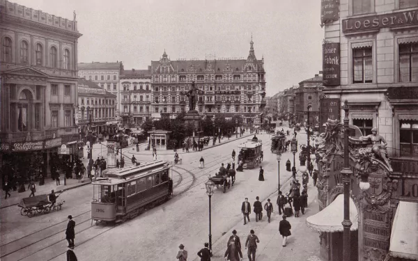 Black-and-white photograph of historic Berlin, Germany: trams, horse-drawn carriages and pedestrians passing ornate buildings — HD PC desktop wallpaper/background.