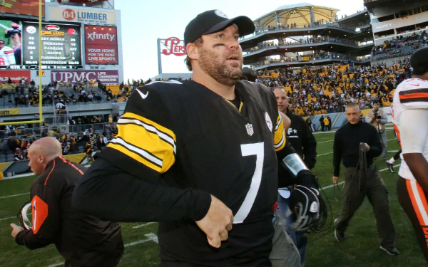 HD PC desktop wallpaper featuring a Pittsburgh Steelers player on the field during a game, showcasing team colors and stadium atmosphere.
