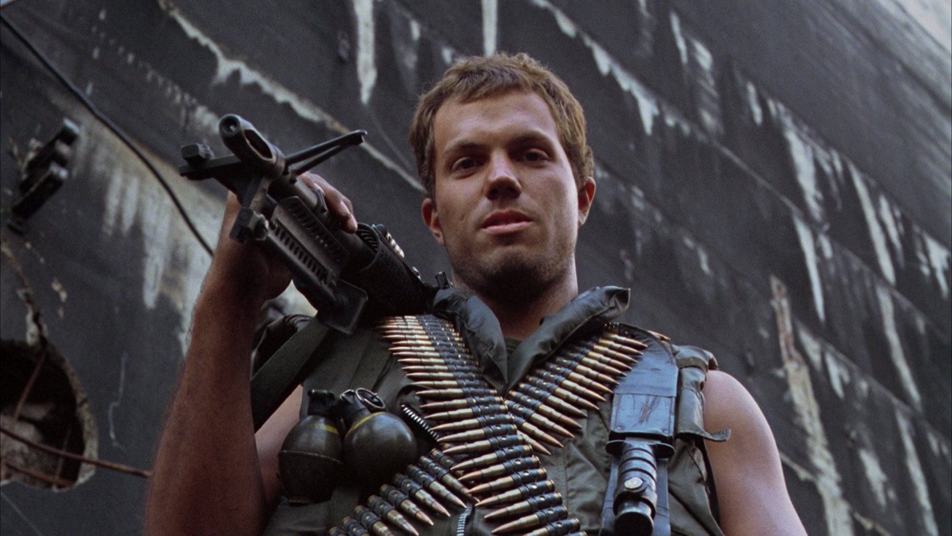 HD desktop wallpaper featuring Adam Baldwin as Animal Mother from the movie Full Metal Jacket, armed and wearing combat gear against a dark urban background.