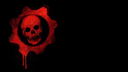 HD PC desktop wallpaper featuring the iconic red cogwheel skull emblem from the video game Gears of War against a black background.