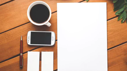 HD PC desktop wallpaper featuring still life photography of a wooden table with a cup of coffee, smartphone, pen, blank paper, and two vertical cards.