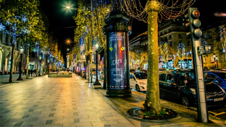 A vibrant Parisian boulevard at night, illuminated by colorful lights, lined with trees and bustling with activity, showcasing the charm of France in a stunning 4K Ultra HD wallpaper.